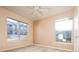 Neutral bedroom features carpet floors, a ceiling fan and two large windows for natural light at 7432 S Quail Cir # 1818, Littleton, CO 80127