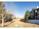 Exterior image featuring the community grounds and building in an open space with mature trees at 7432 S Quail Cir # 1818, Littleton, CO 80127