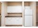 Kitchen boasts ample white cabinets and a full-sized refrigerator at 7432 S Quail Cir # 1818, Littleton, CO 80127