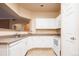 Bright kitchen featuring white cabinetry, countertops, and appliances at 7432 S Quail Cir # 1818, Littleton, CO 80127
