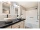 Bathroom featuring double sinks, subway tile, and modern fixtures at 7440 S Blackhawk St # 4-104, Englewood, CO 80112