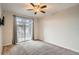 Bedroom featuring a large sliding glass door and neutral carpet at 7440 S Blackhawk St # 4-104, Englewood, CO 80112
