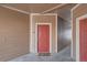 Exterior hallway with red door and charming welcome mat at 7440 S Blackhawk St # 4-104, Englewood, CO 80112