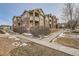 Attractive condo exterior with stone accents and white balcony railings at 7440 S Blackhawk St # 4-104, Englewood, CO 80112