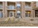 Multi-level home featuring private balconies and attractive stone detailing at 7440 S Blackhawk St # 4-104, Englewood, CO 80112