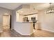 Kitchen view features white cabinets, stainless steel appliances, and open design at 7440 S Blackhawk St # 4-104, Englewood, CO 80112