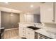Bright kitchen with marble countertops, stainless steel appliances, and a double sink at 7440 S Blackhawk St # 4-104, Englewood, CO 80112