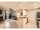 Open layout from kitchen into the cozy living room featuring a fireplace at 7440 S Blackhawk St # 4-104, Englewood, CO 80112