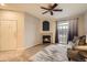 Cozy living room featuring a fireplace, modern ceiling fan, and sliding glass doors at 7440 S Blackhawk St # 4-104, Englewood, CO 80112