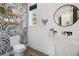 Chic powder room with artistic wallpaper, wood shelving, and modern fixtures at 1711 Boulder St, Denver, CO 80211