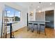 Bright dining area with natural light, bar seating, and modern cabinets at 1711 Boulder St, Denver, CO 80211