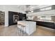 Modern kitchen featuring a central island with bar seating, stainless steel appliances, and sleek cabinetry at 1711 Boulder St, Denver, CO 80211