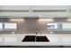 Close-up of a modern kitchen sink and backsplash with clean lines and undermount lighting at 1711 Boulder St, Denver, CO 80211