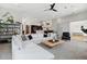 Bright, open-concept living room with stylish decor, a modern ceiling fan, and seamless flow to the kitchen at 1711 Boulder St, Denver, CO 80211