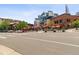 Street view of public square with outdoor dining under red umbrellas and unique building architecture at 1711 Boulder St, Denver, CO 80211