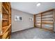 Versatile room with built-in shelving, soft carpeting, natural light, and customizable storage solutions at 81 S Chase Dr, Lakewood, CO 80226