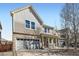 Inviting two-story home featuring a well-maintained lawn, two-car garage, and cozy front porch at 1824 Morningview Ln, Castle Rock, CO 80109