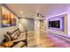 Cozy living room featuring recessed lighting, hardwood floors, and a large, wall-mounted TV at 1824 Morningview Ln, Castle Rock, CO 80109