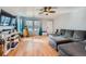 Bright living room featuring a large gray sectional, hardwood floors, and ample natural light at 1824 Morningview Ln, Castle Rock, CO 80109