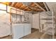 Practical basement laundry area with a washer, dryer, and wire shelving, maximizing functionality at 10956 Osprey Ct, Parker, CO 80134