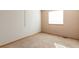 Empty bedroom features a carpeted floor, neutral walls, and a window at 10956 Osprey Ct, Parker, CO 80134