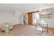 Spacious bonus room with comfortable seating, a desk area, and a sliding barn door, enhancing the living space at 10956 Osprey Ct, Parker, CO 80134
