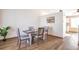 Bright dining area featuring modern wood floors, a stylish table set for four, and neutral decor at 10956 Osprey Ct, Parker, CO 80134