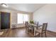 Stylish dining room features a unique brick wall, ample natural light, and a cozy ambiance with a dining table at 10956 Osprey Ct, Parker, CO 80134