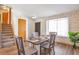 Elegant dining room showcasing a brick accent wall, a cozy window nook, and a modern table setting at 10956 Osprey Ct, Parker, CO 80134