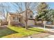 Inviting two-story home with a cozy front porch, attached garage, and lush green lawn with mature trees at 10956 Osprey Ct, Parker, CO 80134