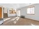 Spacious living room with stairs and railing leading to kitchen, glass door, and large window at 10956 Osprey Ct, Parker, CO 80134