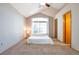 Light and airy bedroom with brick accent wall and vaulted ceilings at 10956 Osprey Ct, Parker, CO 80134