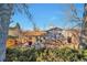 Backyard featuring a deck, patio seating, a grill, and mature trees at 13742 W 67Th Pl, Arvada, CO 80004