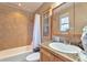 Bathroom with tiled walls, shower/tub combo, and a vanity with granite countertop at 13742 W 67Th Pl, Arvada, CO 80004