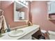 Cozy bathroom with long countertop, large mirror, and a functional layout at 13742 W 67Th Pl, Arvada, CO 80004