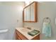 Bathroom showcasing a vanity with a modern faucet and a wall-mounted mirror at 13742 W 67Th Pl, Arvada, CO 80004
