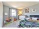 Bright bedroom featuring playful decor, large window, and comfortable furnishings at 13742 W 67Th Pl, Arvada, CO 80004