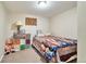 Bedroom featuring a bed with colorful patterned quilt, accent pillows, and storage at 13742 W 67Th Pl, Arvada, CO 80004