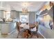 Dining room with round wooden table, stylish light fixture, and vibrant wall art at 13742 W 67Th Pl, Arvada, CO 80004