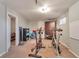 Finished basement exercise room with carpeted floors, exercise bikes, and fitness accessories at 13742 W 67Th Pl, Arvada, CO 80004