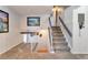 Inviting foyer with neutral carpet, a staircase leading upstairs, and stylish decor at 13742 W 67Th Pl, Arvada, CO 80004