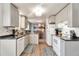 Efficient kitchen with white appliances, sleek countertops, and an open layout leading to the dining area at 13742 W 67Th Pl, Arvada, CO 80004