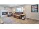 Cozy living room with a fireplace, comfortable seating, and natural light creating a warm atmosphere at 13742 W 67Th Pl, Arvada, CO 80004