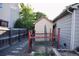 Fenced backyard featuring a shed and a raised garden bed at 11384 Oakland Dr, Commerce City, CO 80640