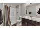 Modern bathroom features a shower with glass door, a sleek vanity and ample storage space at 11384 Oakland Dr, Commerce City, CO 80640