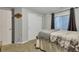 Cozy bedroom featuring neutral carpet, gray walls, and a window with bright, natural light at 11384 Oakland Dr, Commerce City, CO 80640