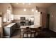 Bright kitchen features white cabinets, stainless appliances, and a large island with seating for a modern look at 11384 Oakland Dr, Commerce City, CO 80640