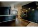 Stylish living room boasting dark accent walls, modern lighting and wood flooring at 11384 Oakland Dr, Commerce City, CO 80640