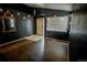 Chic living room with dark walls, stylish mirror, tile entry, and bright window at 11384 Oakland Dr, Commerce City, CO 80640
