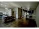 Open-concept living room showcasing wood floors, vaulted ceilings, and a fireplace at 11384 Oakland Dr, Commerce City, CO 80640